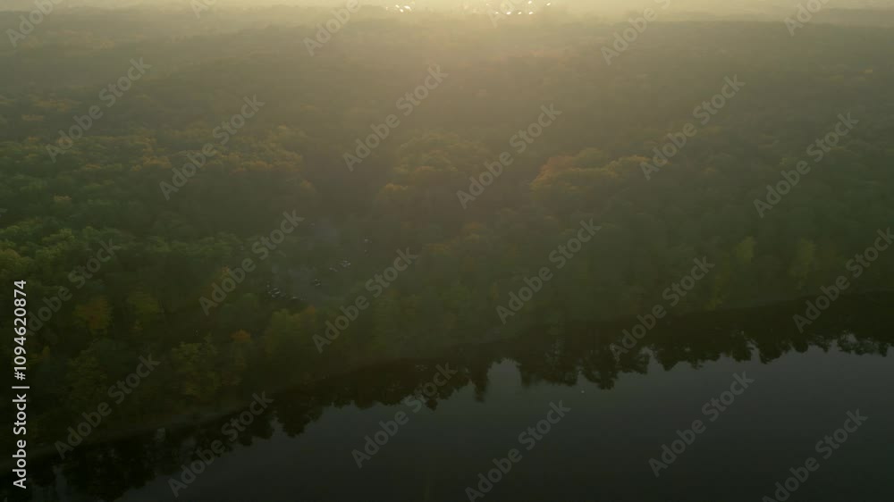 A tranquil forested landscape with a river at sunrise, aerial view A tranquil forested landscape with a river at sunrise, aerial view