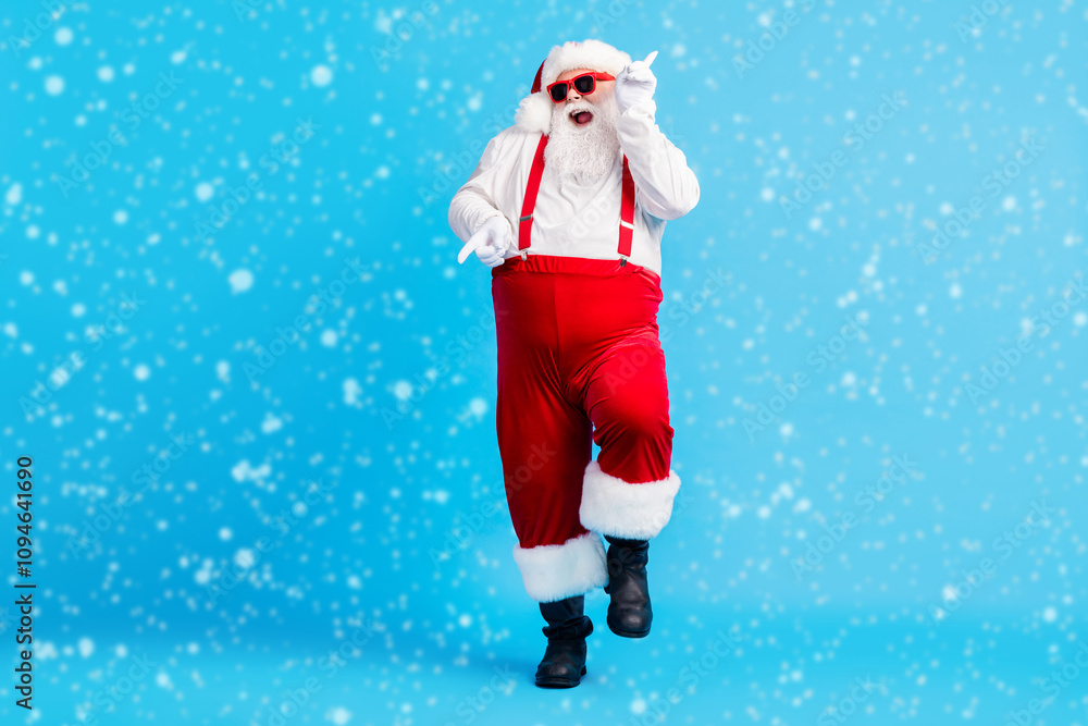 Full size photo of funky fat crazy santa claus with big abdomen beard dance x-mas christmas holly party club wear suspenders overalls sunglass boots isolated blue color background Full size photo of funky fat crazy santa claus with big abdomen beard dance x-mas christmas holly party club wear suspenders overalls sunglass boots isolated blue color background