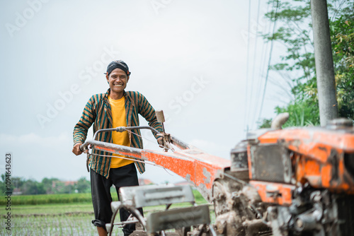 A hardworking man skillfully operates a tractor on fertile farmland for effective cultivation