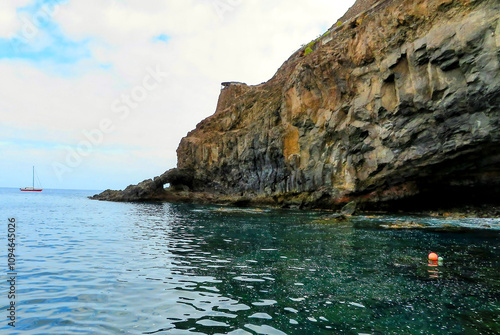 Saint Helena’s coastline with clear turquoise waters and rugged rock formations. A peaceful view that captures the island’s untouched coastline.. photo