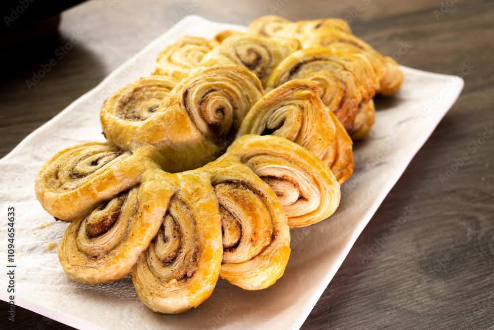 Puff pastry flowers with cinnamon sugar.Puff pastry. Dessert. Cinnamon. Sugar. Food concept Puff pastry flowers with cinnamon sugar.Puff pastry. Dessert. Cinnamon. Sugar. Food concept