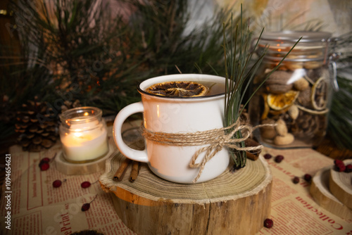 Cozy decorated tea mug with pine branches on a Christmas atmosphere background