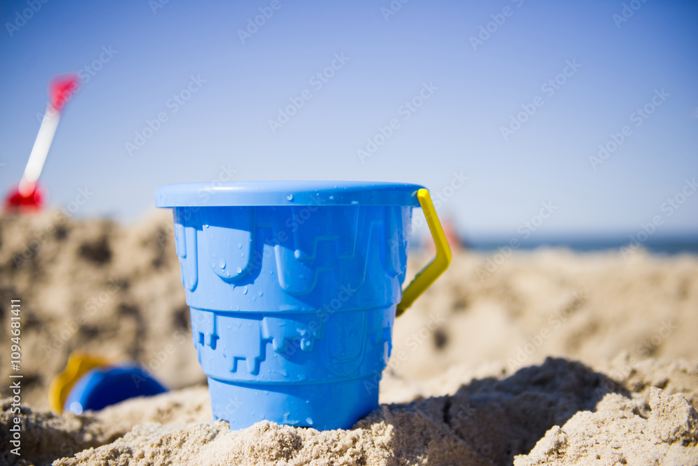Blue toy bucket on the beach Blue toy bucket on the beach