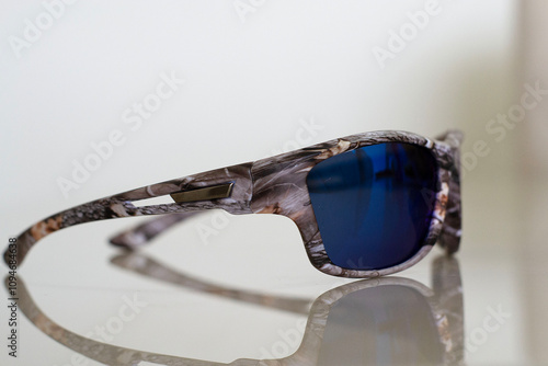 blue and camouflaged tactical sunglasses military model photo