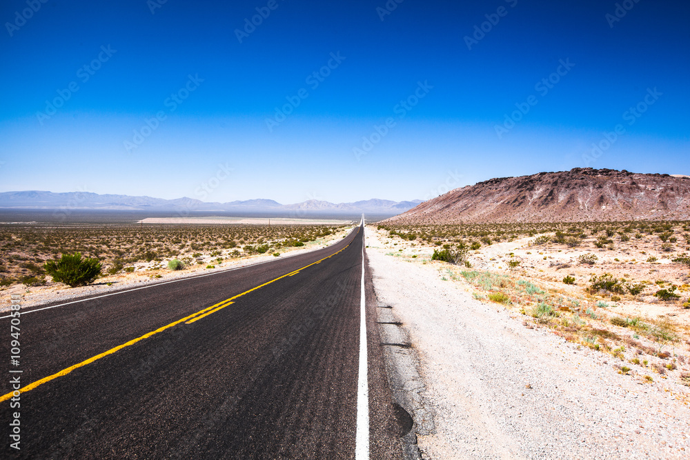 Empty scenic road in a Death Valley National Park , Nevada , USA Empty scenic road in a Death Valley National Park , Nevada , USA