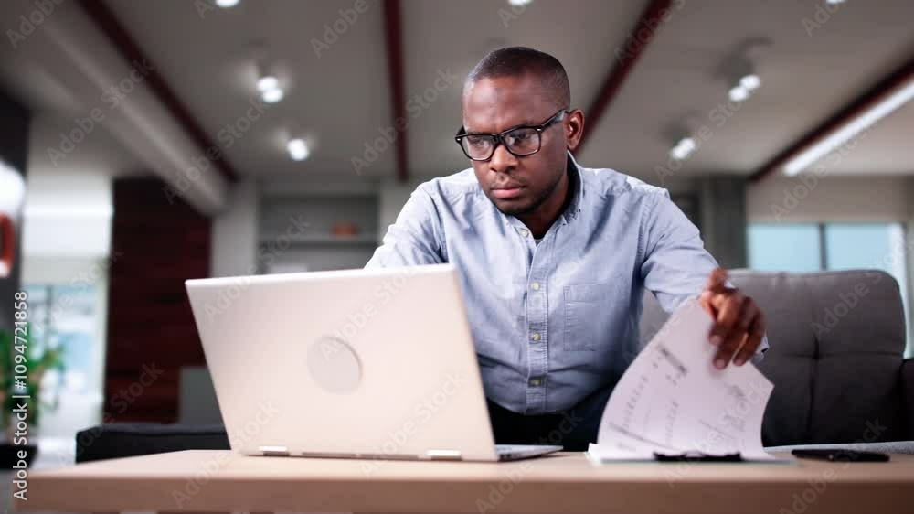 Young African Man Calculating Invoice Young African Man Calculating Invoice