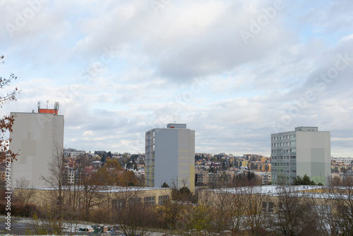 Three tall buildings rise impressively against a cloudy sky, adding depth and drama to the scene photo