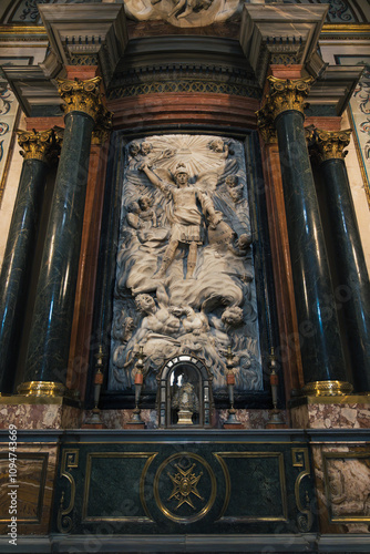 Old christian sculpture of an angel over demons in a church in Seville, Spain