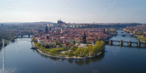 Prague's Old Town, seen from above in spring, shows the Charles Bridge arching over the Vltava River. The castle is visible in the distance.