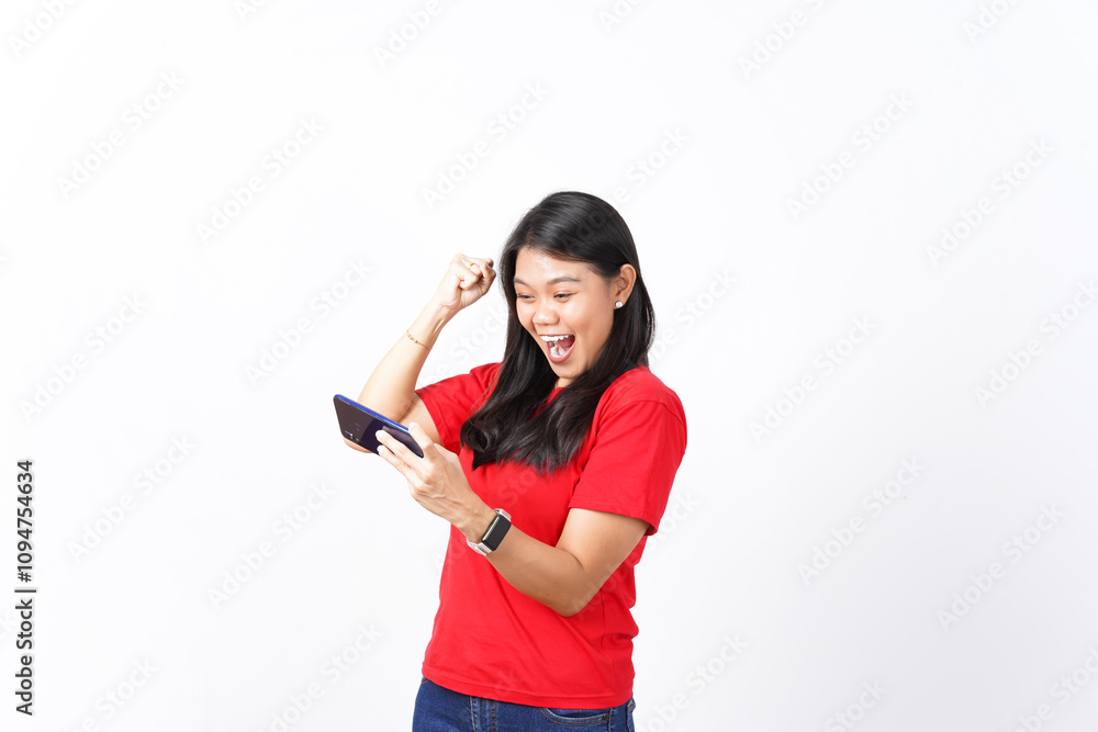 beautiful Asian woman shows excitement, celebrating a game win while holding a smartphone against a white background beautiful Asian woman shows excitement, celebrating a game win while holding a smartphone against a white background