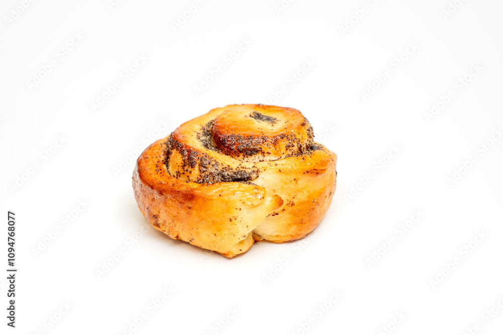 A cinnamon roll sits on a white background. The roll is brown and has a hole in the middle A cinnamon roll sits on a white background. The roll is brown and has a hole in the middle