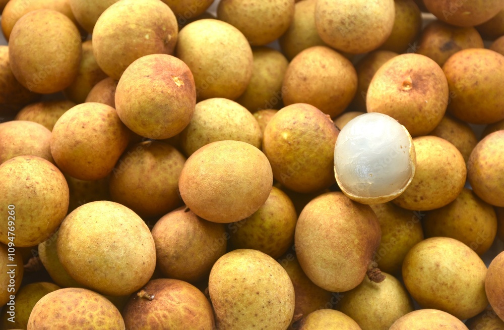 close up of longan tropical fruit peeling out in batch background and texture close up of longan tropical fruit peeling out in batch background and texture