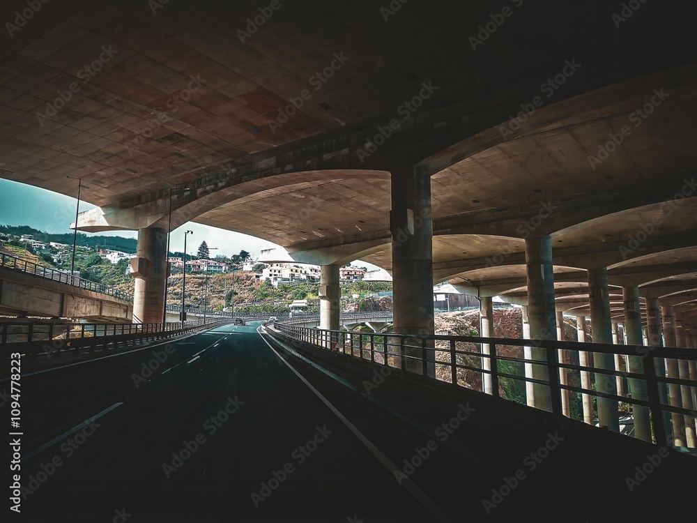 View from below the Santa Cruz Airport runway, with concrete columns supporting the structure, Madeira. View from below the Santa Cruz Airport runway, with concrete columns supporting the structure, Madeira.