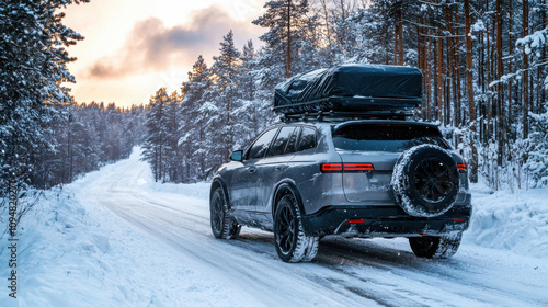 Suv car with rooftop cargo carrier trunk stay on roadside of winter road. Family trip to ski resort. Winter holidays adventure. car on winter road