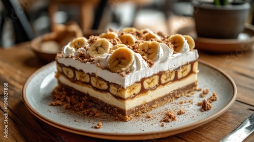Wallpaper Mural A decadent slice of banoffee pie showcasing layers of banana, toffee, and whipped cream, beautifully plated on a rustic wooden table. Torontodigital.ca