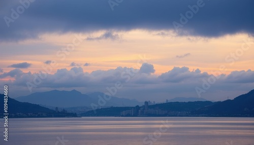 view of a city and mountains from a lake