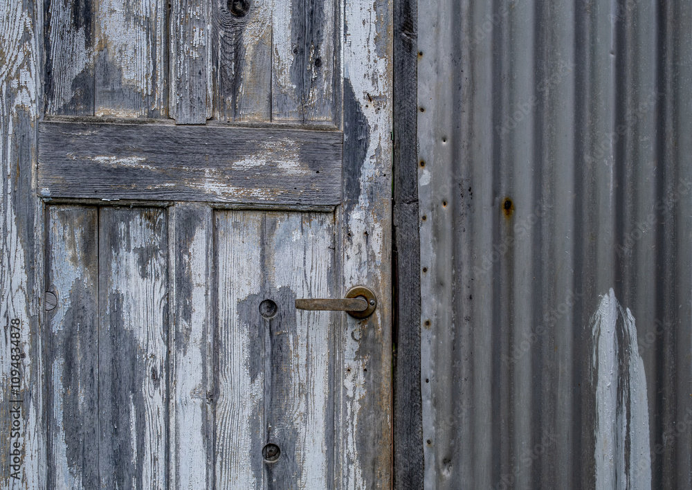 An old wooden door in the fence is a close-up. An old wooden door in the fence is a close-up.
