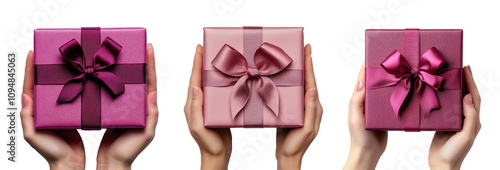 hand holding a gift in pink packaging with a bow on a transparent background