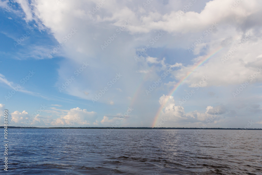 Rainbow in the amazon sky, over the great amazon river, Iquitos Peru Rainbow in the amazon sky, over the great amazon river, Iquitos Peru