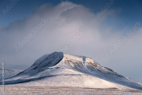 Snow-Covered Mountain against Cloudy Sky