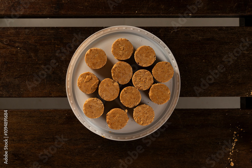 Sweet Brazilian Peanut Called Paçoca on a wooden desk photo