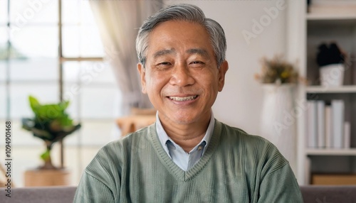 Happy senior man looking at camera at home photo