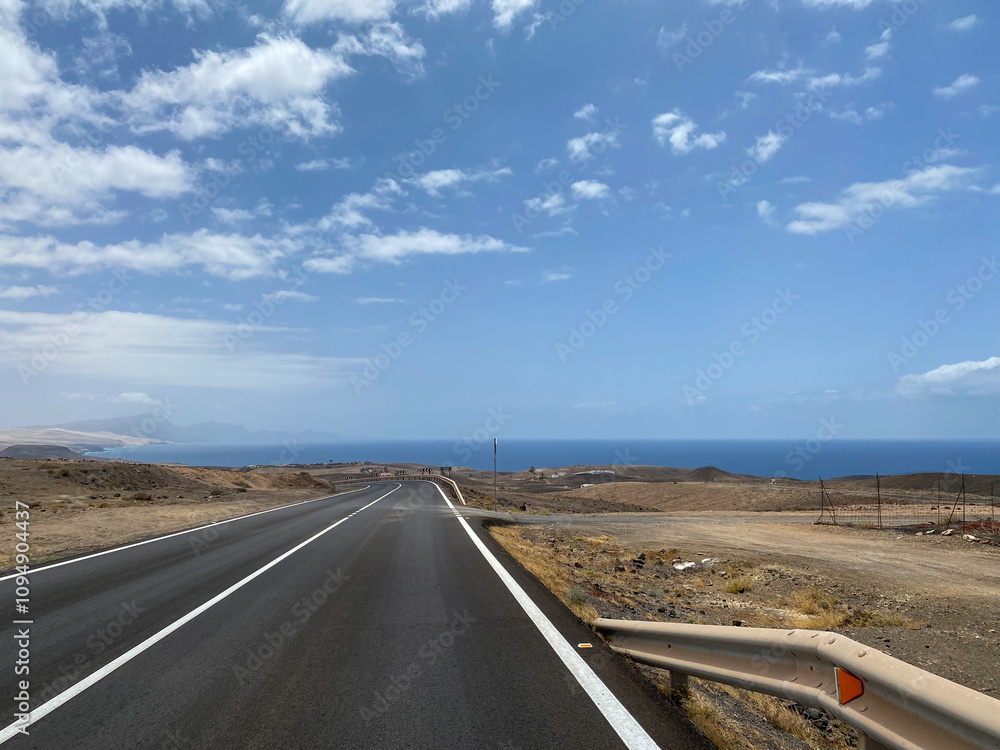 Empty road in a sandy desert ocea side Empty road in a sandy desert ocea side