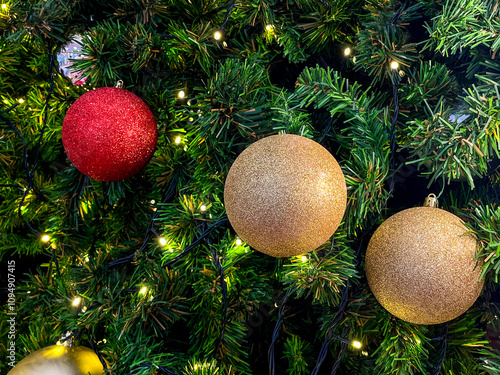 A beautifully decorated Christmas tree adorned with colorful ornaments , illuminated by warm string lights, creating a joyful holiday ambiance.