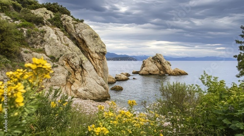 A rocky shoreline with a large rock in the water photo