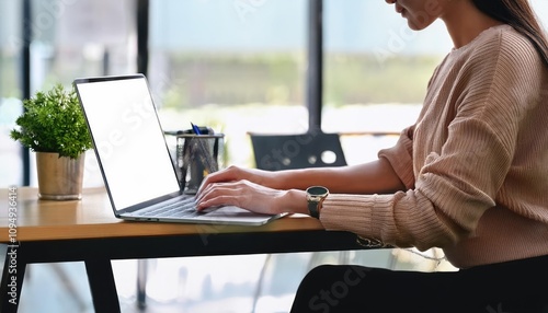 Woman working on laptop with white screen in office  photo