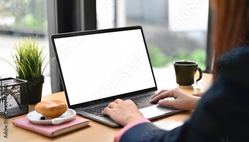 Woman working on laptop with white screen in office 