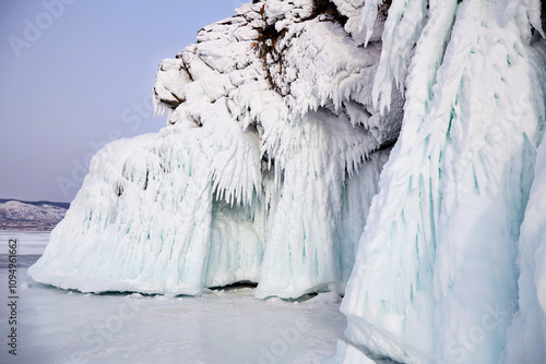 Ice cliffs of Olkhon Island. Icicles are frozen splashes of water on rocks during a storm. Frozen Lake Baikal. Winter landscape.  photo