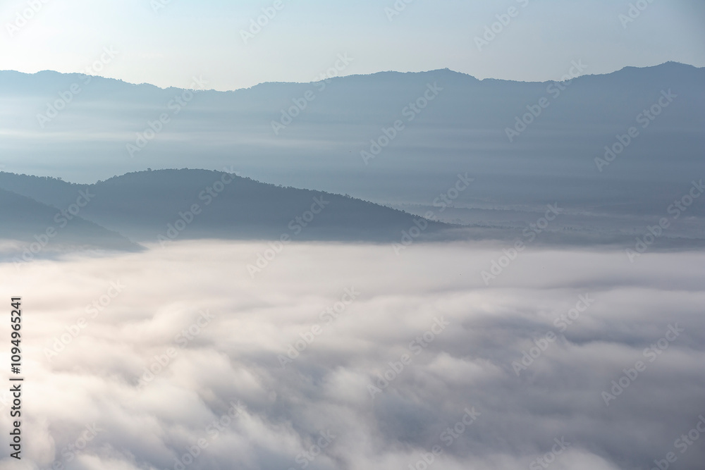 The weather is hot and humid, with a lot of water vapor creating a sea of mist in the foreground in the valley The weather is hot and humid, with a lot of water vapor creating a sea of mist in the foreground in the valley