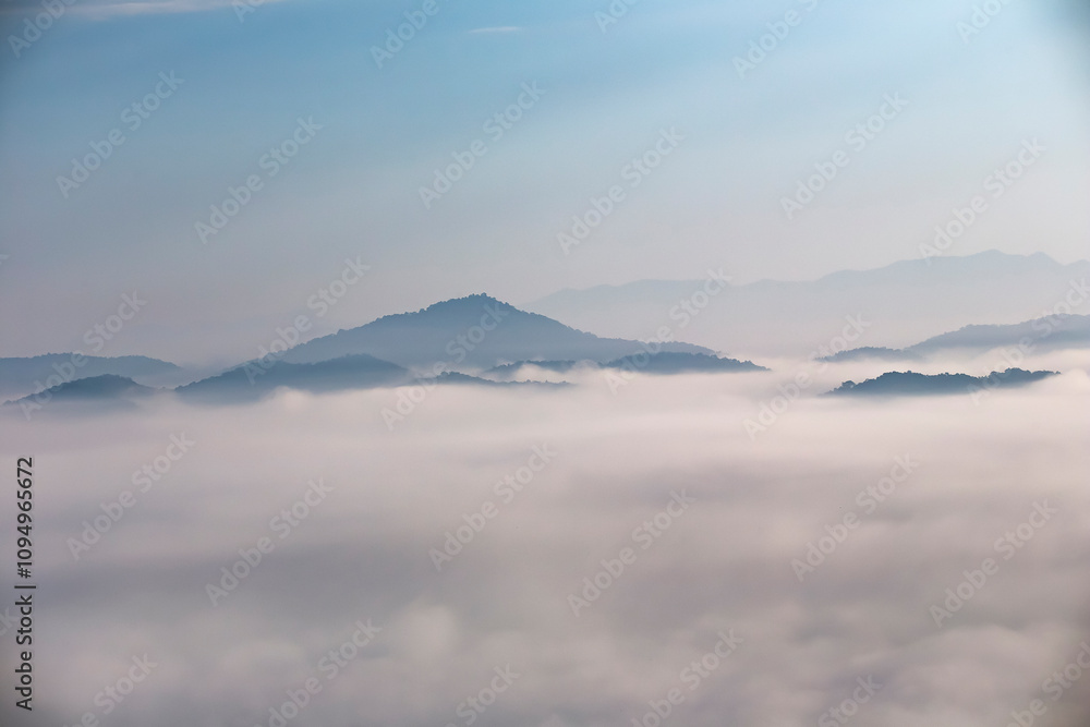 The weather is hot and humid, with a lot of water vapor creating a sea of mist in the foreground in the valley The weather is hot and humid, with a lot of water vapor creating a sea of mist in the foreground in the valley