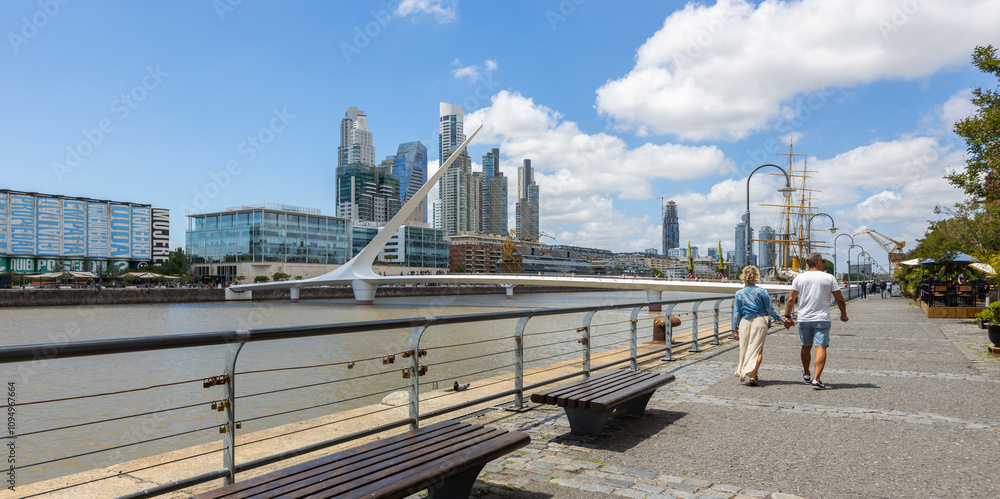 Panoramic view of a couple enjoying a walk on a sunny day in the neighborhood of Puerto Madero, Buenos Aires, Argentina