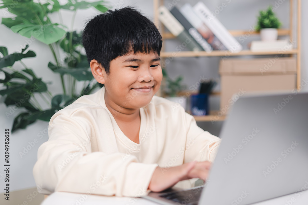Educational of tech concept, Staying at home, Little Asian boy student using computer laptop learning, Presenting a modern educational way of life,, Virtual internet online class from school teacher. Educational of tech concept, Staying at home, Little Asian boy student using computer laptop learning, Presenting a modern educational way of life,, Virtual internet online class from school teacher.