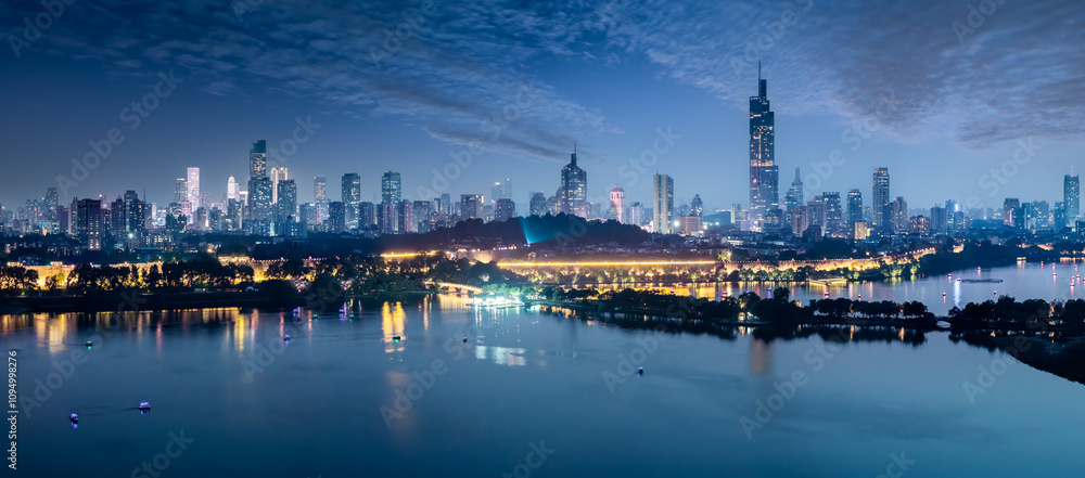 Modern city buildings skyline and lake at night in Nanjing, China Modern city buildings skyline and lake at night in Nanjing, China