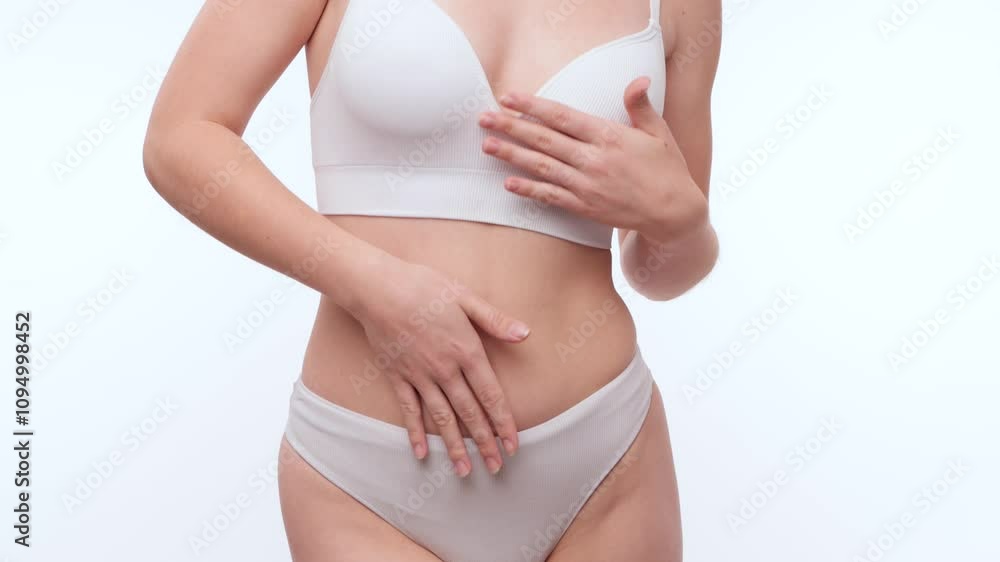 A slender swarthy woman in white underwear on a white background. Healthy lifestyle, sport and diet. A slender swarthy woman in white underwear on a white background. Healthy lifestyle, sport and diet.