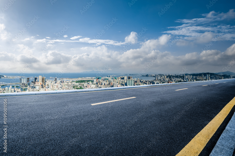Fototapeta premium Empty asphalt road and city skyline with mountains landscape