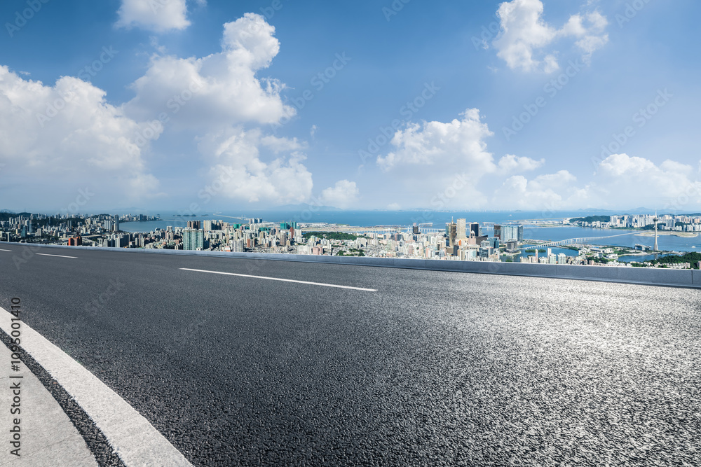 Fototapeta premium Empty asphalt road and city skyline with mountains landscape