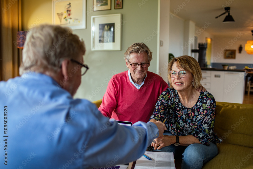 Senior couple talking to financial advisor at home Senior couple talking to financial advisor at home
