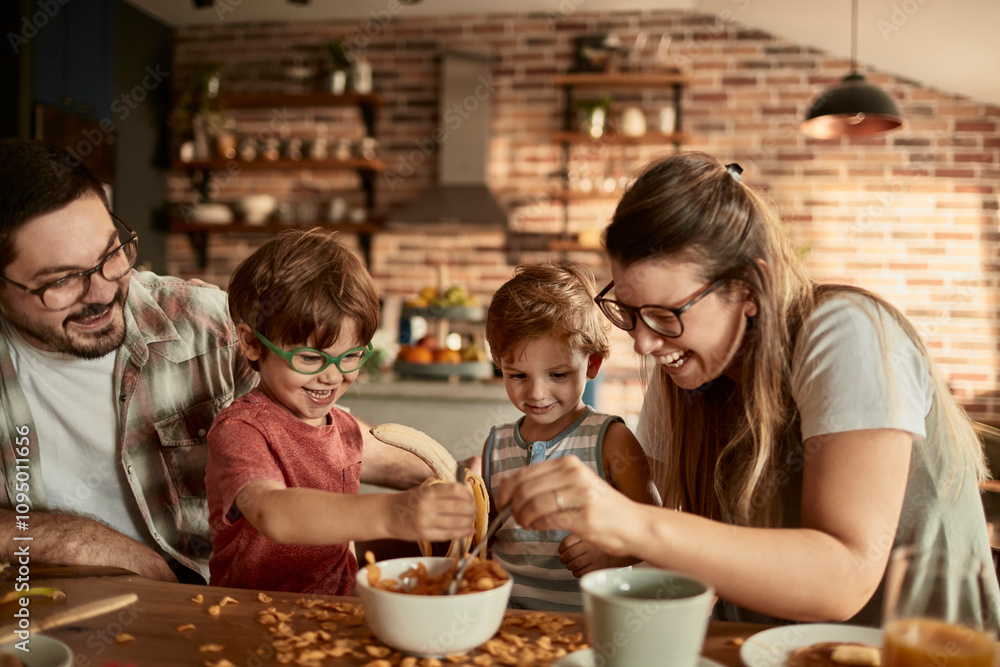 Happy family having breakfast together in cozy kitchen Happy family having breakfast together in cozy kitchen