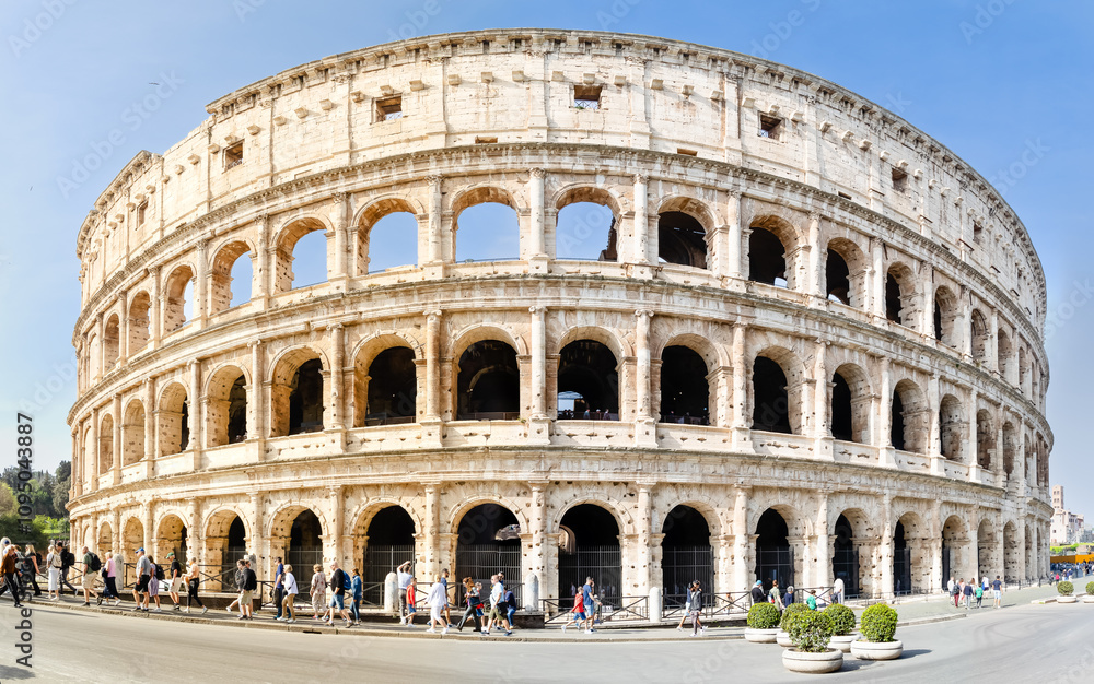 Obraz premium Rome, Italy - April 09, 2024: Ruins of the Coliseum with tourists strolling among the archaeological remains in Rome, Italy