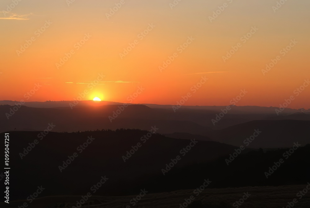 Sunset Over Hills A peaceful sunset over rolling hills evoking a Sunset Over Hills A peaceful sunset over rolling hills evoking a