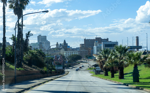Port Elizabeth, South Africa. Driving to the city, high rise buildings, palm trees and cloudy blue sky