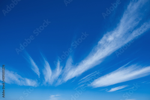 Canvas Print Clear blue sky with light, white clouds background.