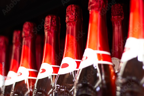 Obraz na płótnie Champagne bottles with red foil in a wine cellar w salonie