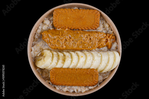 Perfect breakfast with whole oat, oat milk, chia seeds, banana, fresh blueberries, natural peanut butter and honey on black background