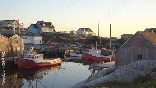 Sailing boats sitting in the picturesque harbour with rocks and wooden fishermen houses 4K 