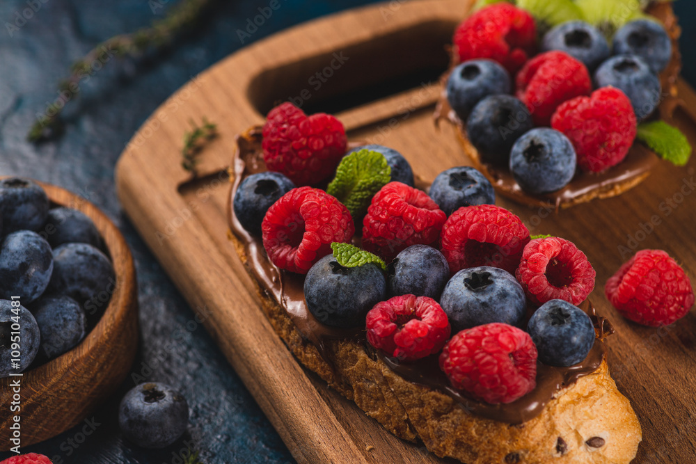 Sandwiches with chocolate paste, raspberries and blueberries Sandwiches with chocolate paste, raspberries and blueberries